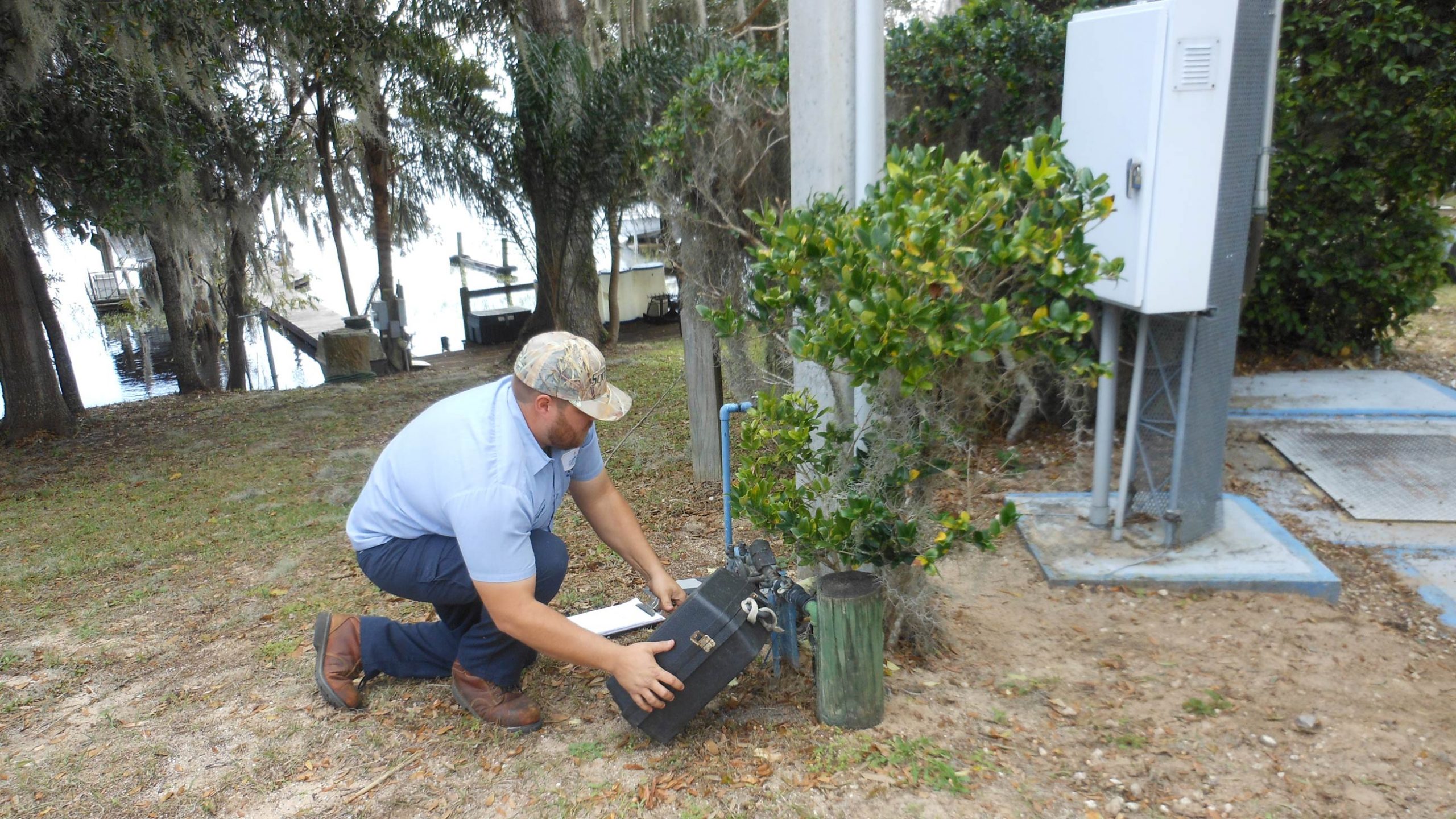 A Clermont Utilities worker repairs a homeowner’s water meter.
