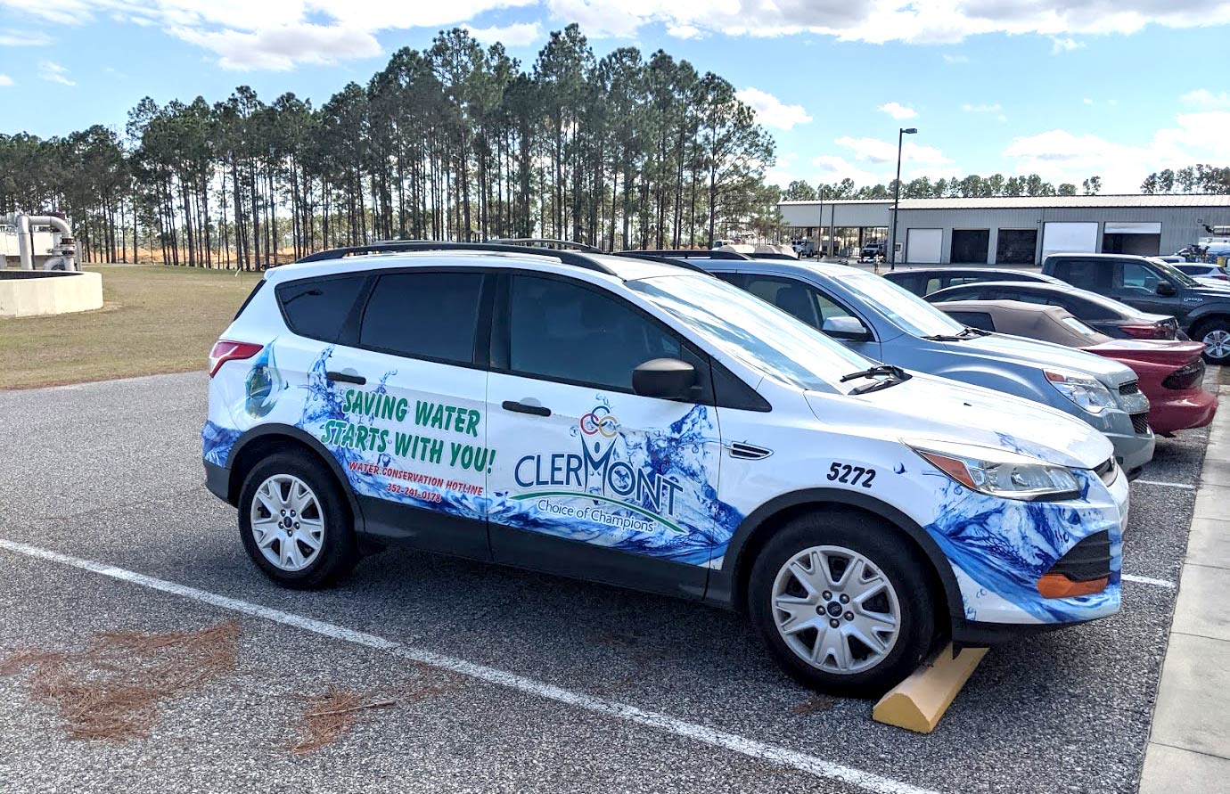 The Clermont Utilities vehicle with a colorful car wrap