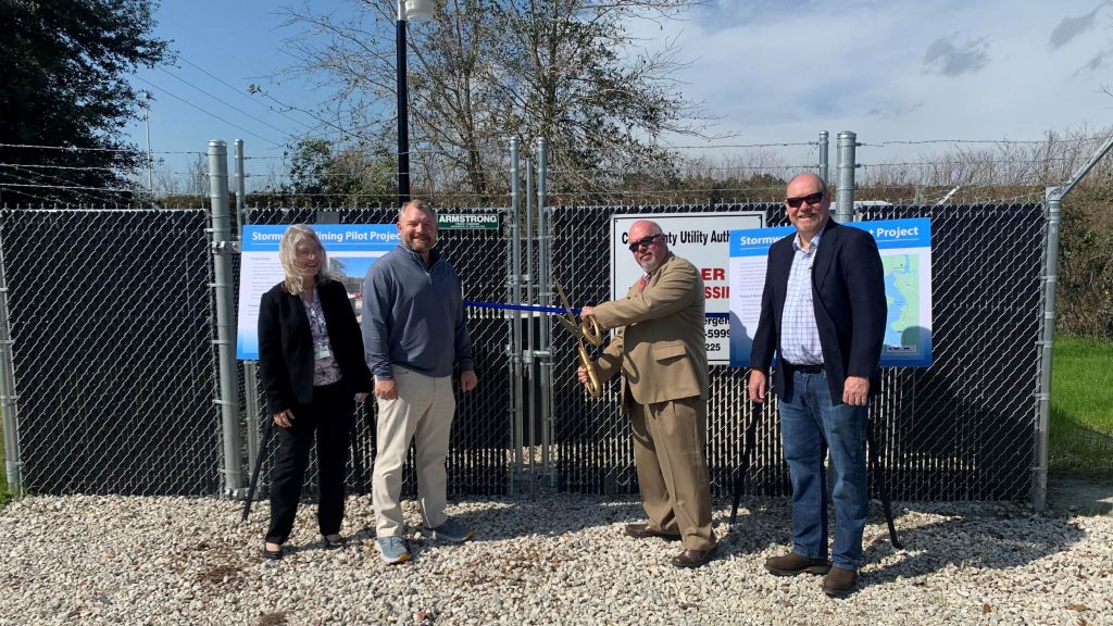District director and board members participating in a ribbon-cutting