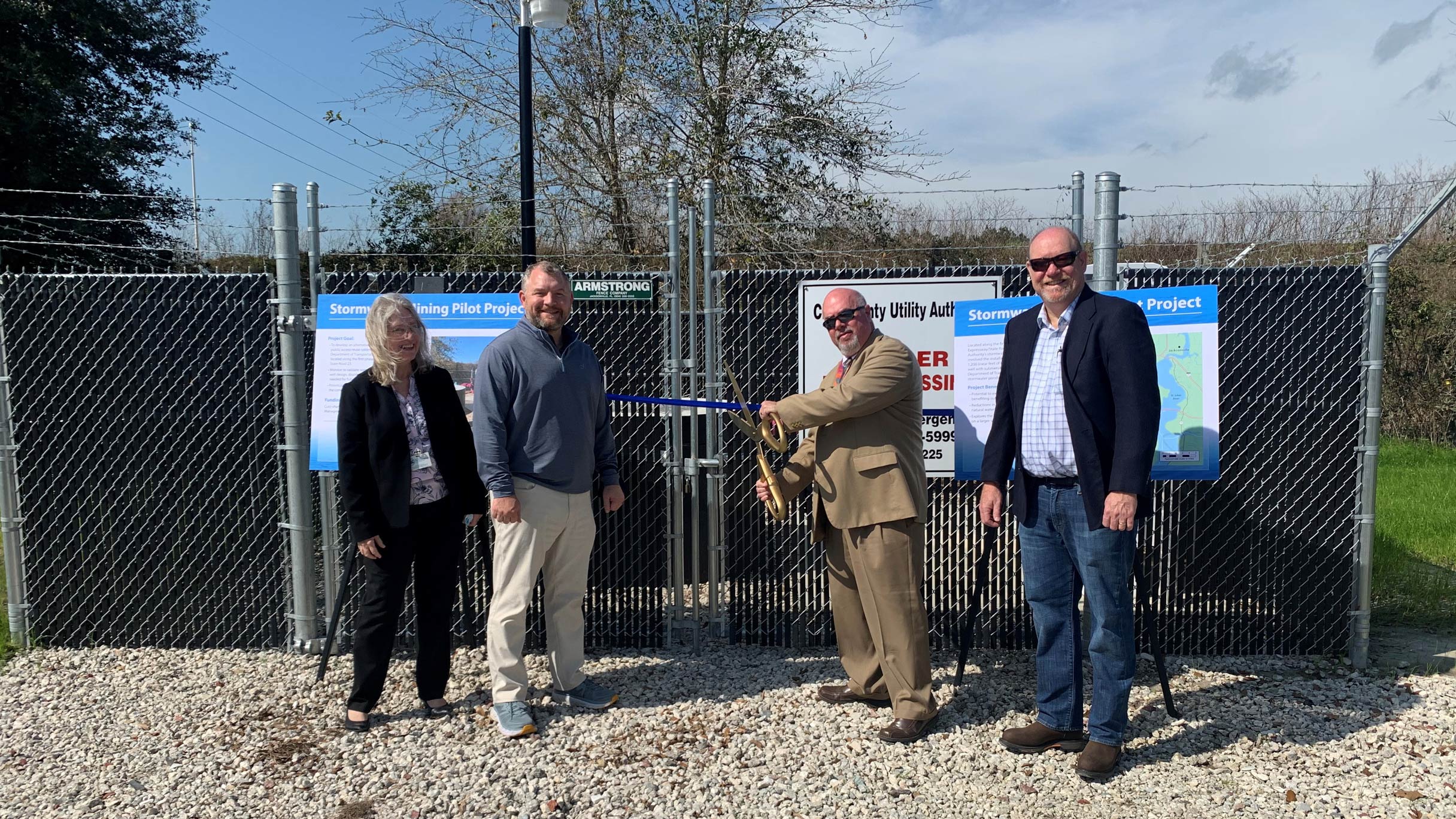 District director and board members participating in a ribbon-cutting