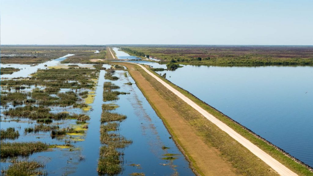 Aerial view of a levee separating 2 bodies of water