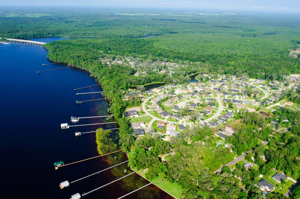Aerial view of a residential community by a river