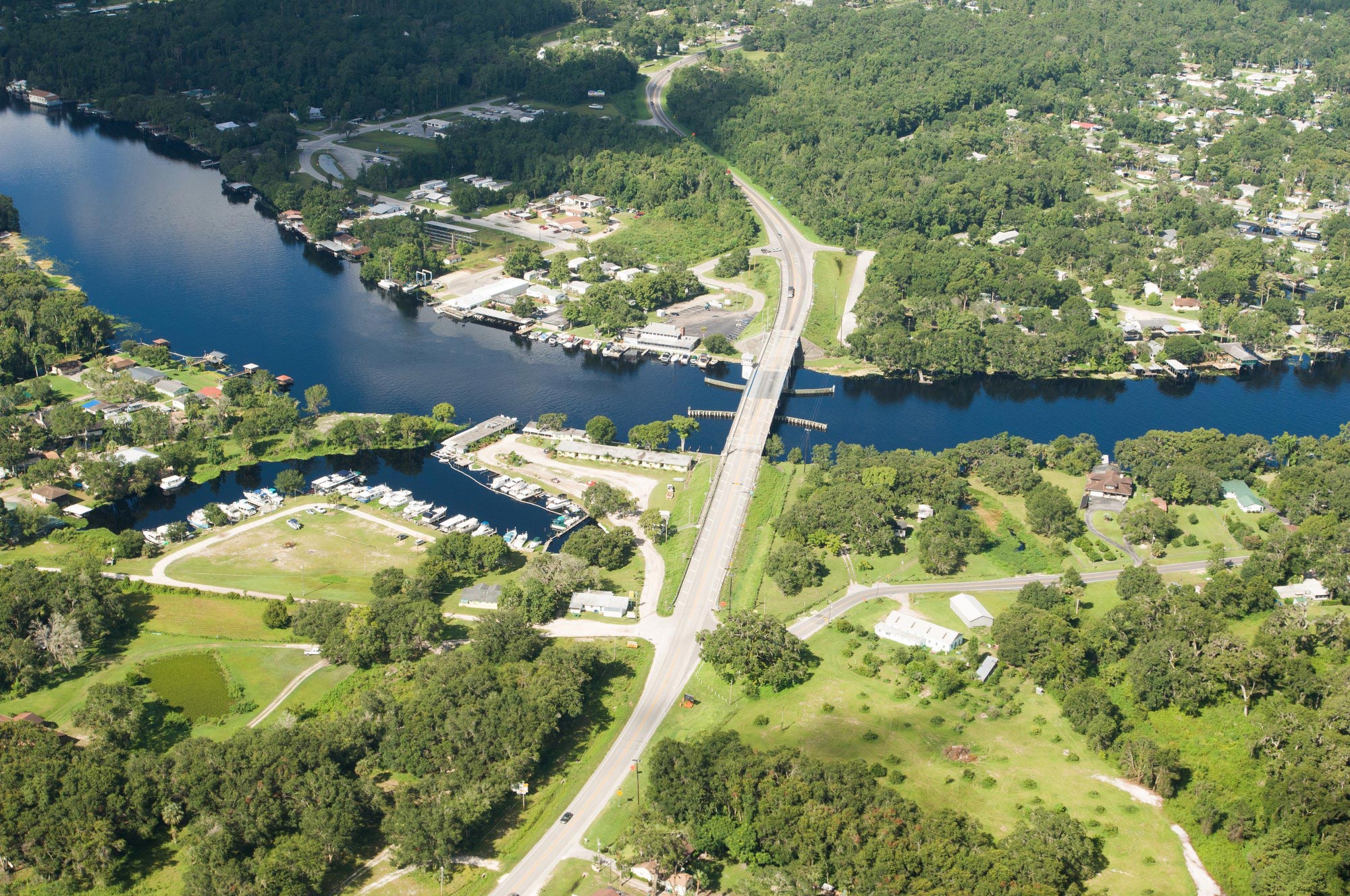 Aerial view of a river cutting through a community