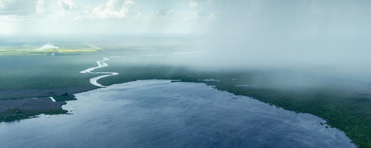 Aerial view of a rain storm moving over Florida lands