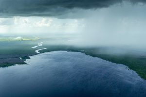 Aerial view of a rain storm moving over Florida lands