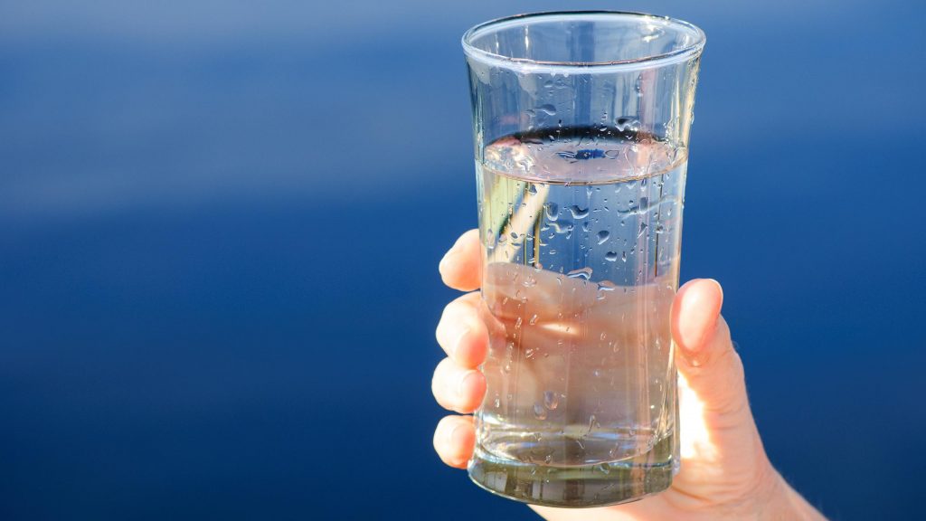 Person holding a glass of water