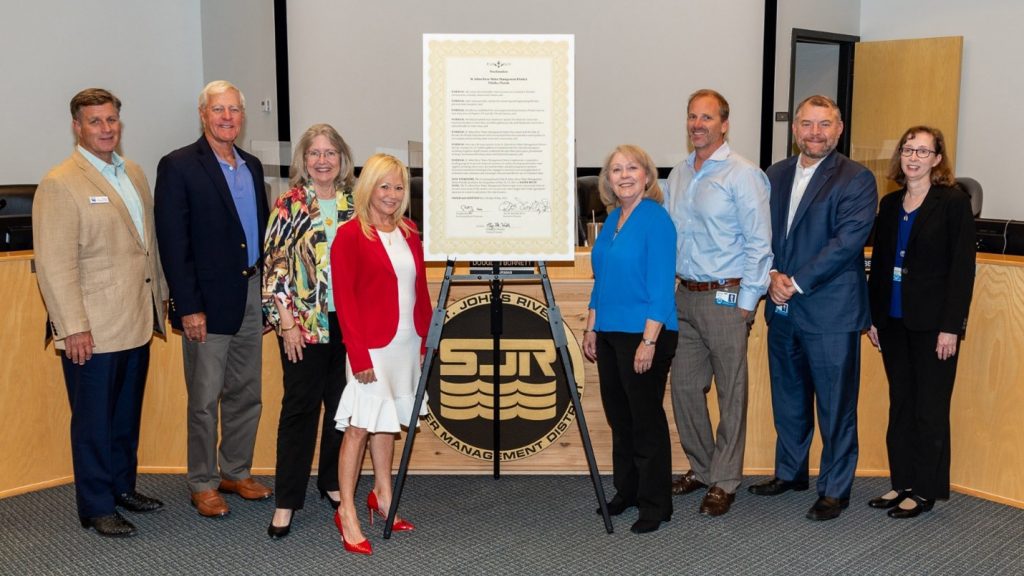 Governing board members standing next to a declaration