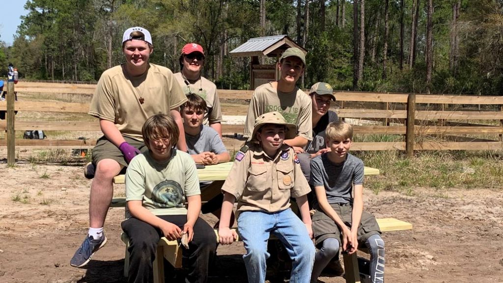 Several Boy Scouts posing on a bench