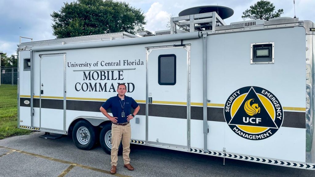 Brent Saulsbury standing next to the command trailer