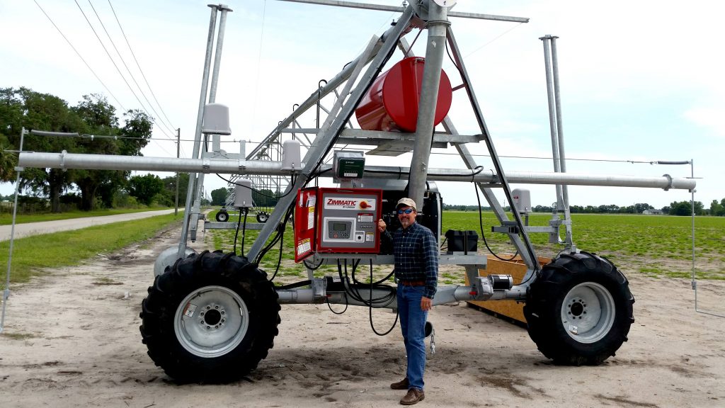 Man standing by a large farm machine