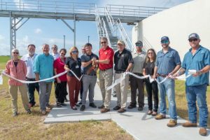 Eustis-event-1-768x512 Lisa Kelley and project partners cutting a ribbon at a Eustis wastewater plant event