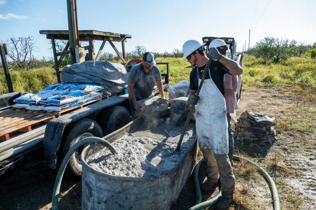 wn1-1 Workmen mix a cement slurry used to plug an abandoned well