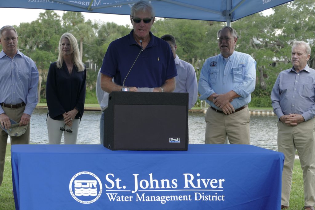 Doug Bournique speaking at a podium