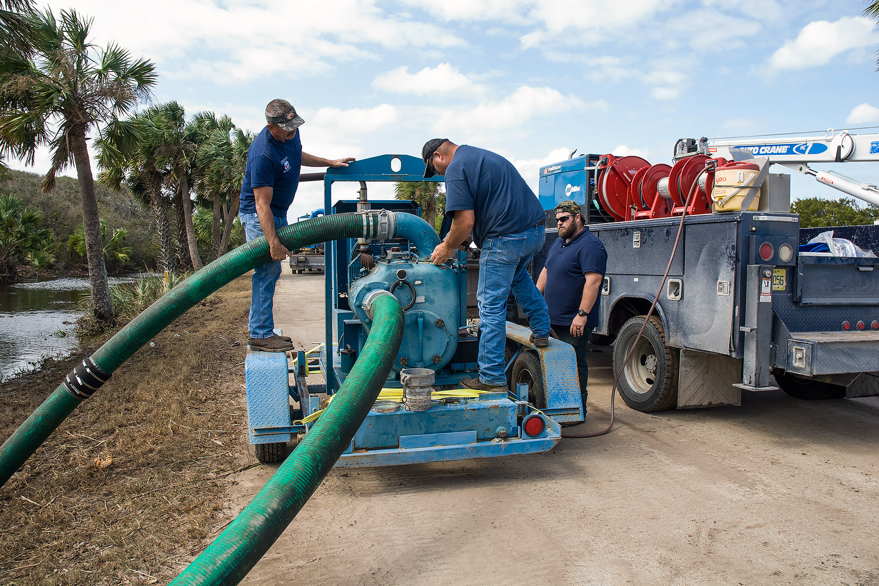 People working with a large water pump