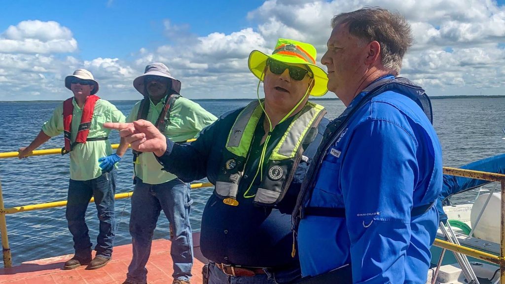 Vince Seibold talking with Michael A. Register on a boat