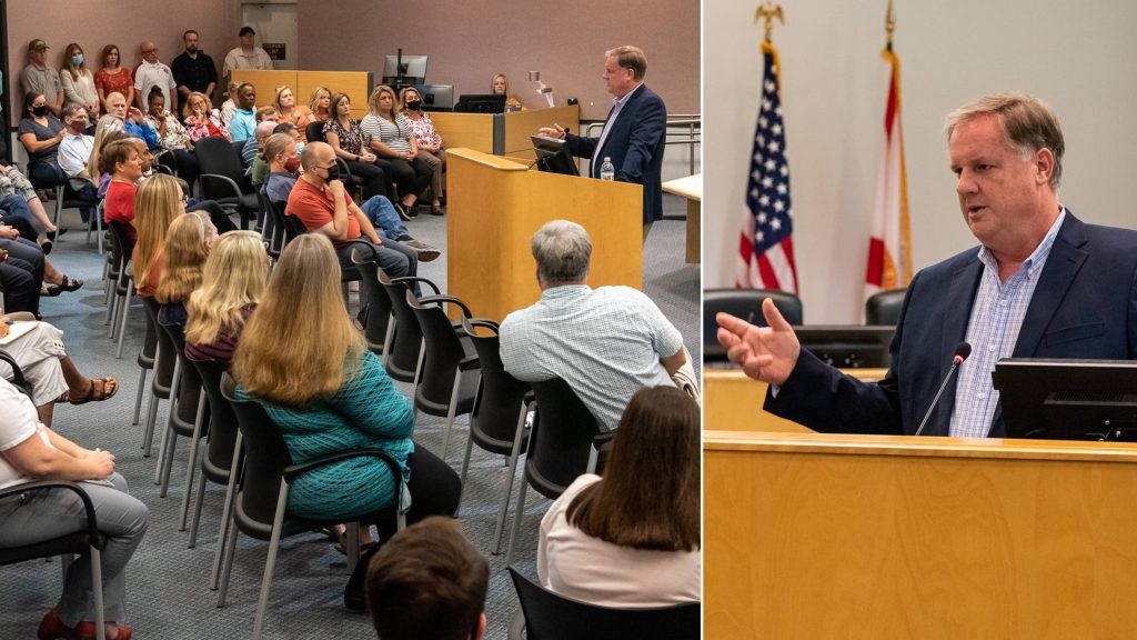 Michael A. Register speaking to staff