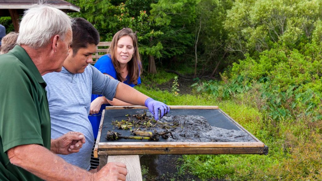 Jennifer Mitchel teaching a student about water quality