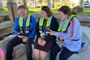 Mike Register sitting next to two women