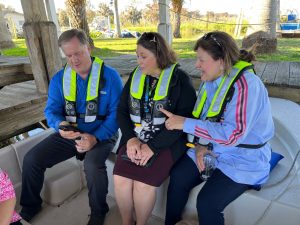 Mike Register sitting next to two women