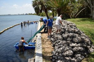 District employees working at a river shore
