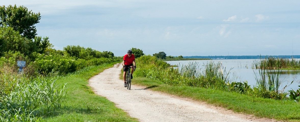 Man riding a bicycle on a dirt road