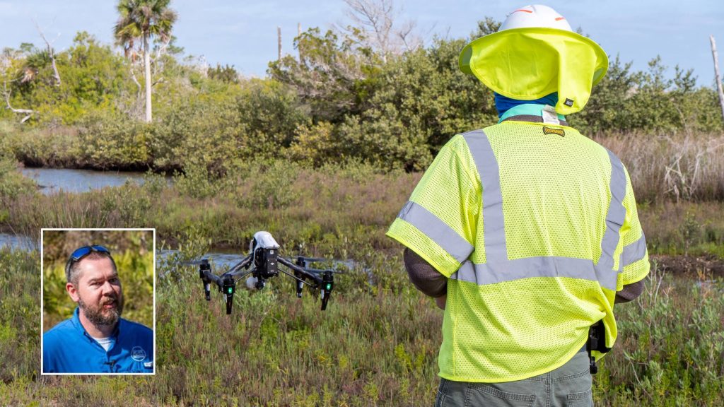 A District drone pilot lands a drone after mapping a restoration project