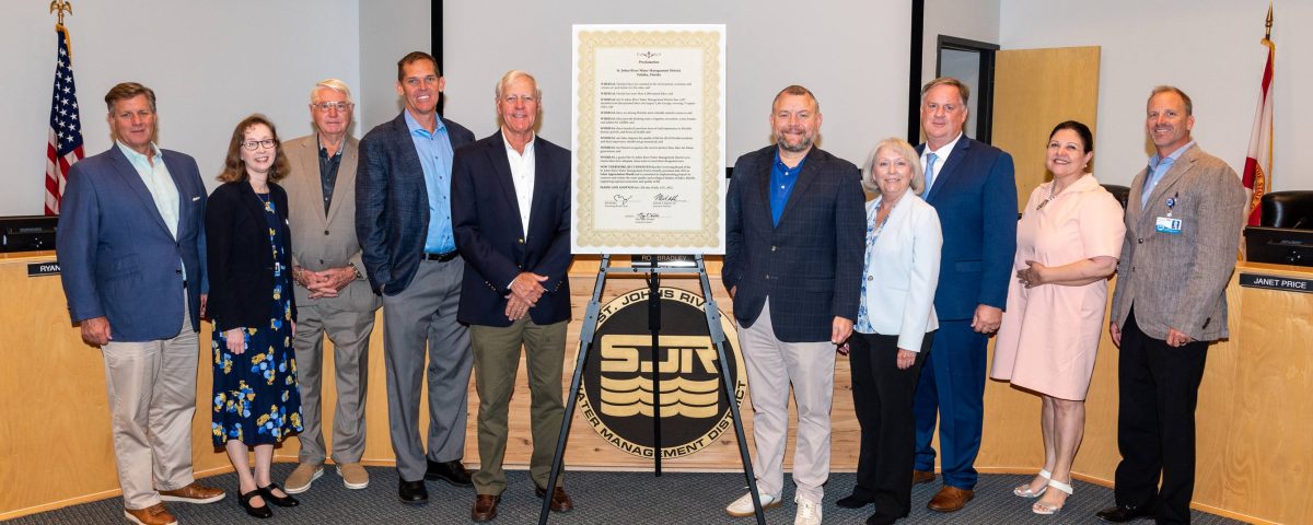 Board members taking a picture with several other people