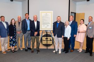 Board members taking a picture with several other people