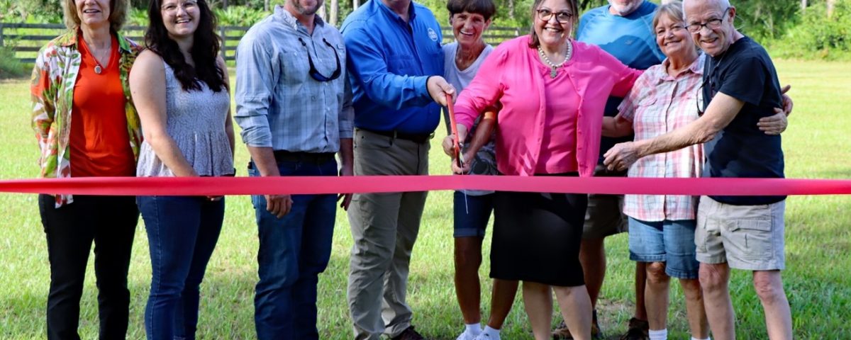 Group of people cutting a ribbom