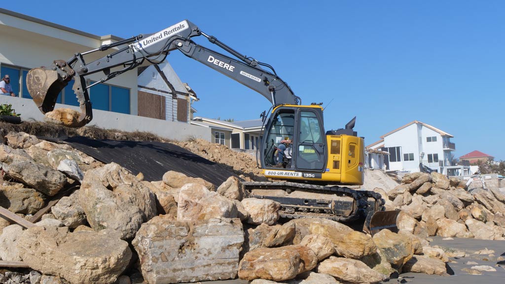 Excavator moving rocks