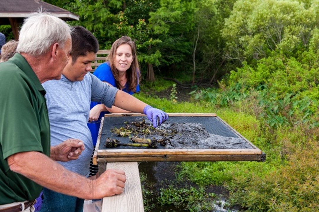 Student examining a muddy screen