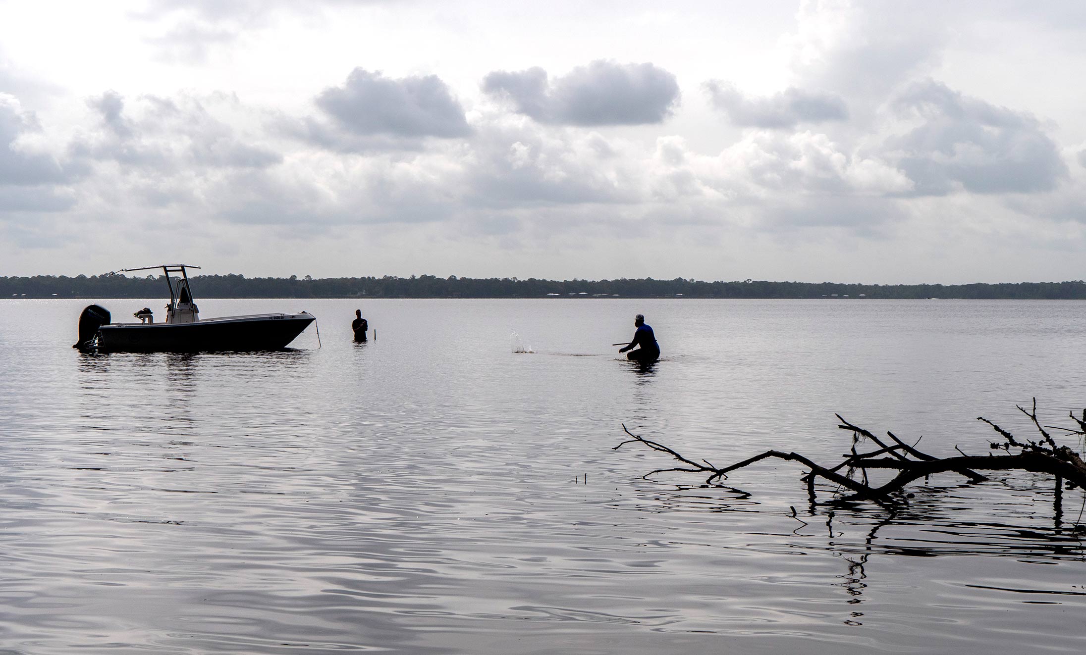 District staff members wade in the river to collect data