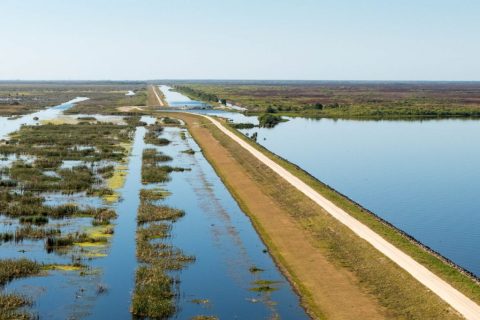 Aerial view of a road next to a body of water