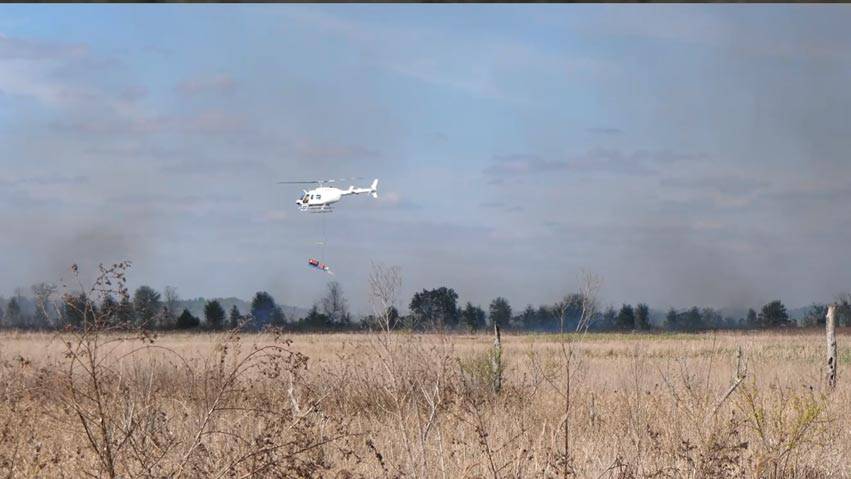 Helicopter lighting a prescribed fire