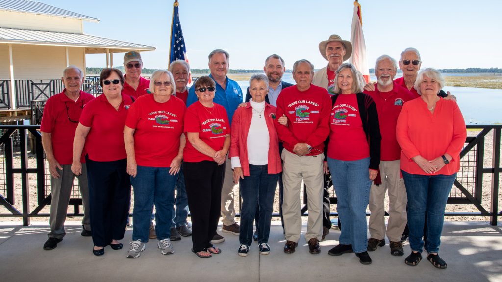 Group of people standing in front of a large banner