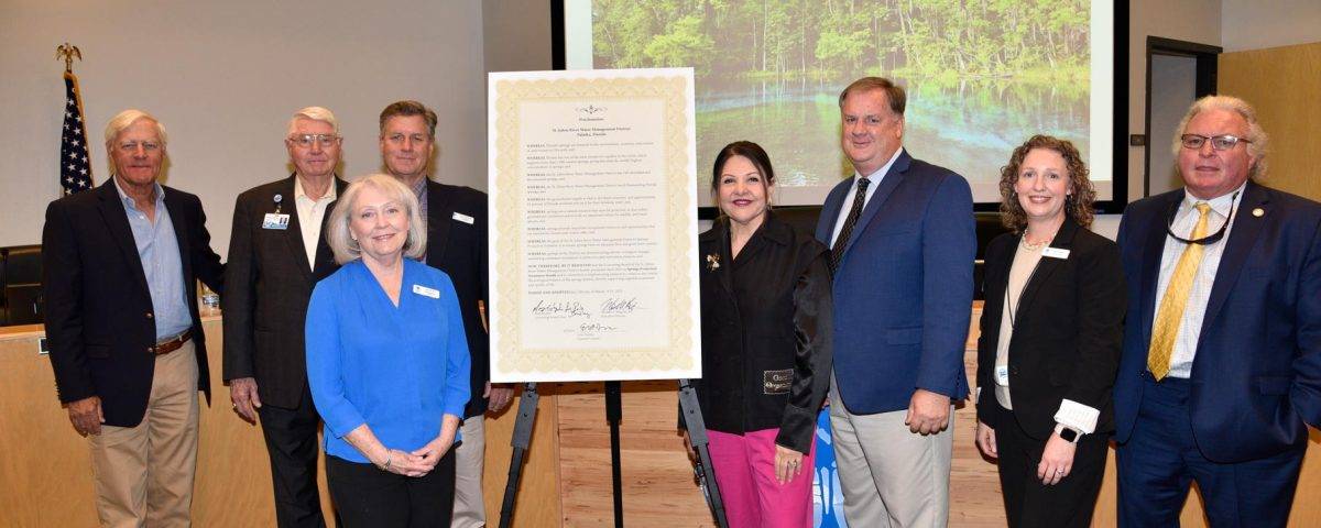 Board members standing by a proclamation