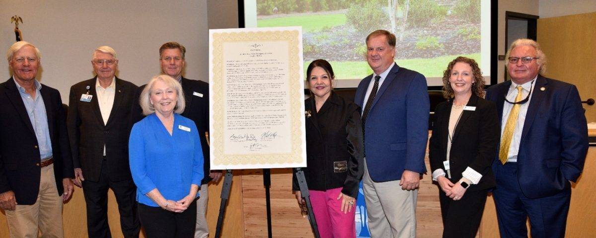 Governing board members pictured by a proclamation