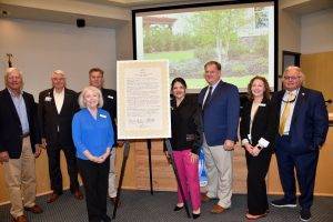 Governing board members pictured by a proclamation