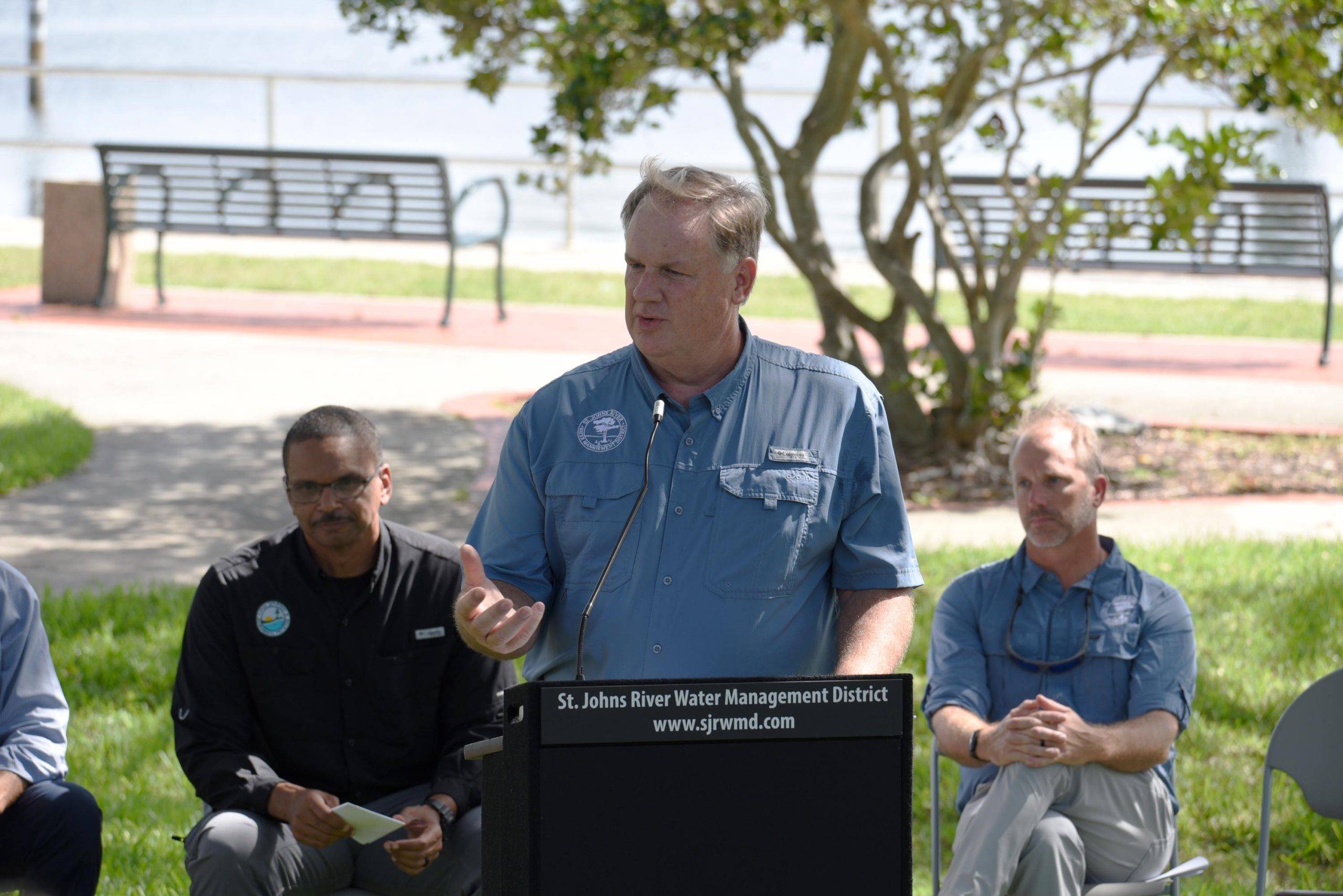 Mike Register welcomes guests at a podium