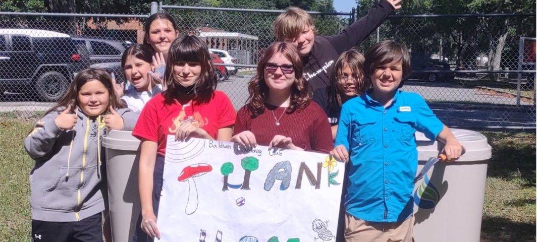Students holding a sign