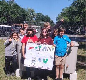 Students holding a sign