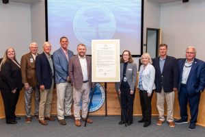 Governing board members pictured next to a proclamation
