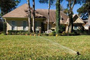 Sprinklers spraying water on a trimmed lawn