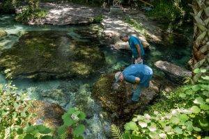 Two men inspecting a spring