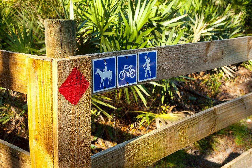 Trail markers on a wooden fence