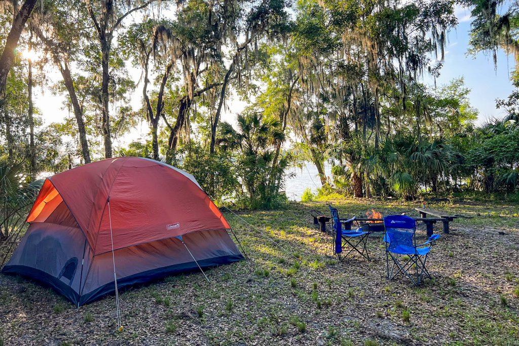 A tent setup at a riverfront campsite