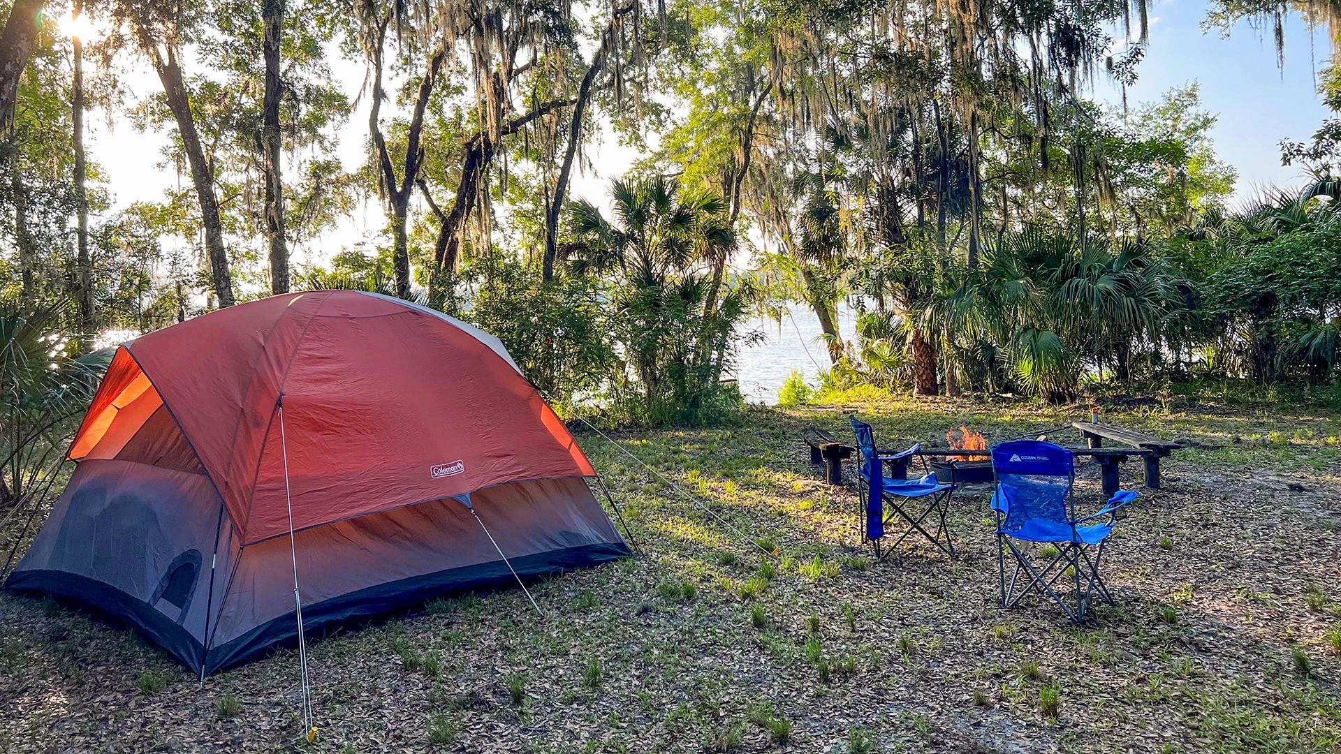 A tent setup at a riverfront campsite