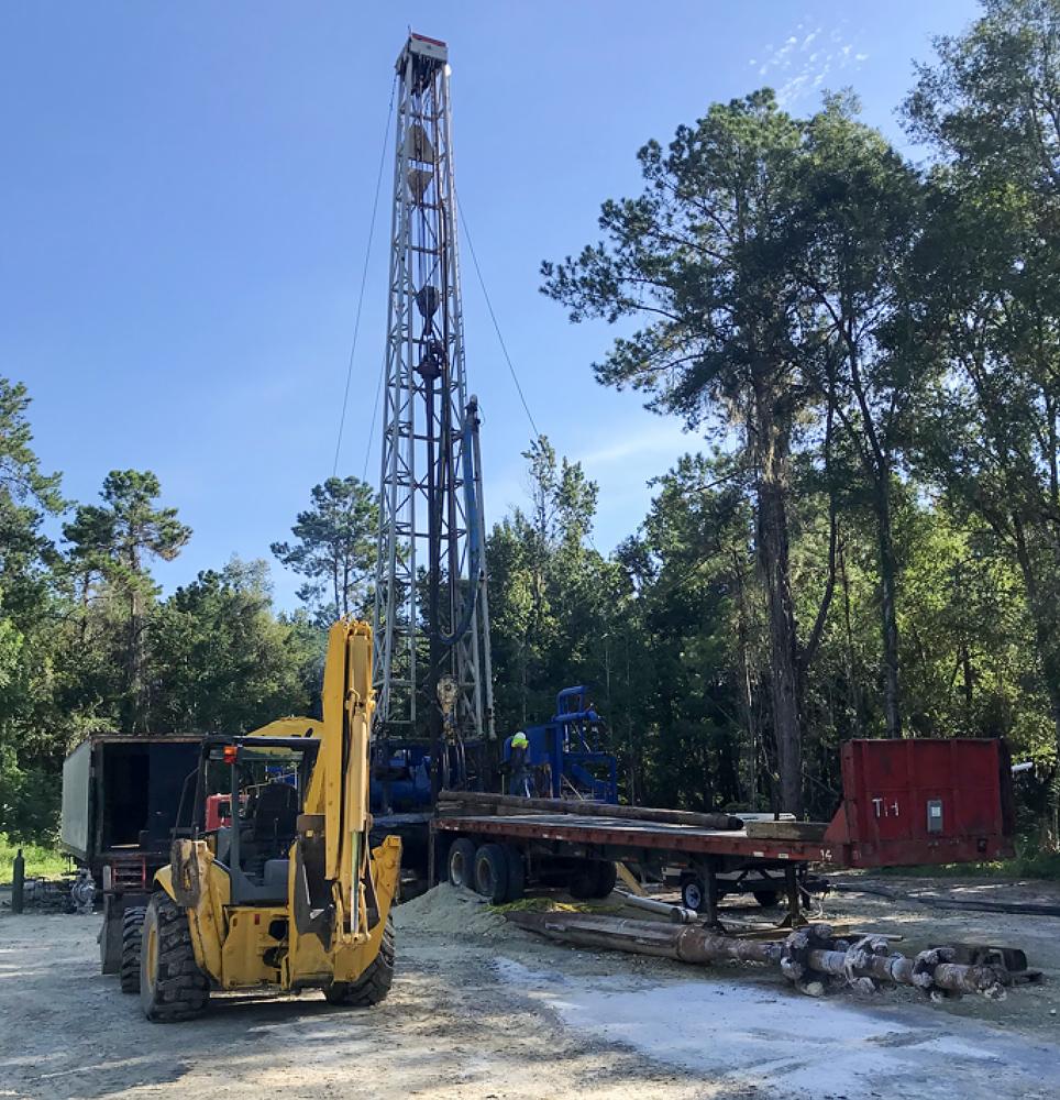 A tractor working at a well drilling site