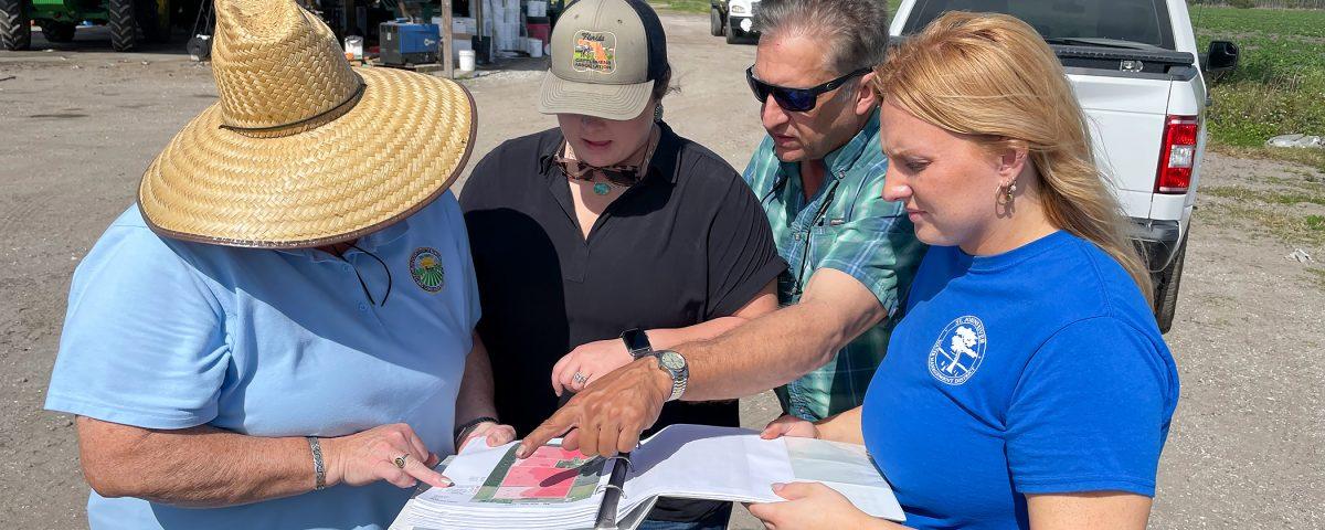 People having a discussion out on a farm