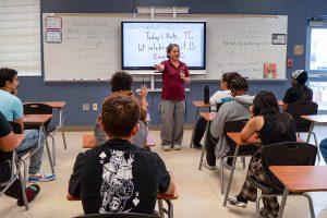 A high school teacher lectures in a classroom
